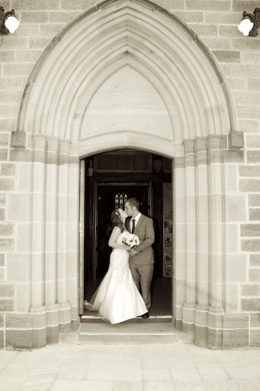 Bride & groom kissing outside church - wedding photography sydney